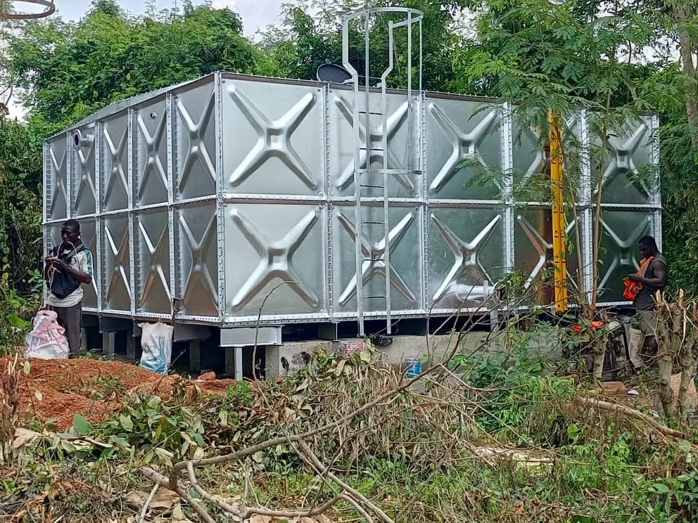 Silver pressed steel water tank with an access ladder